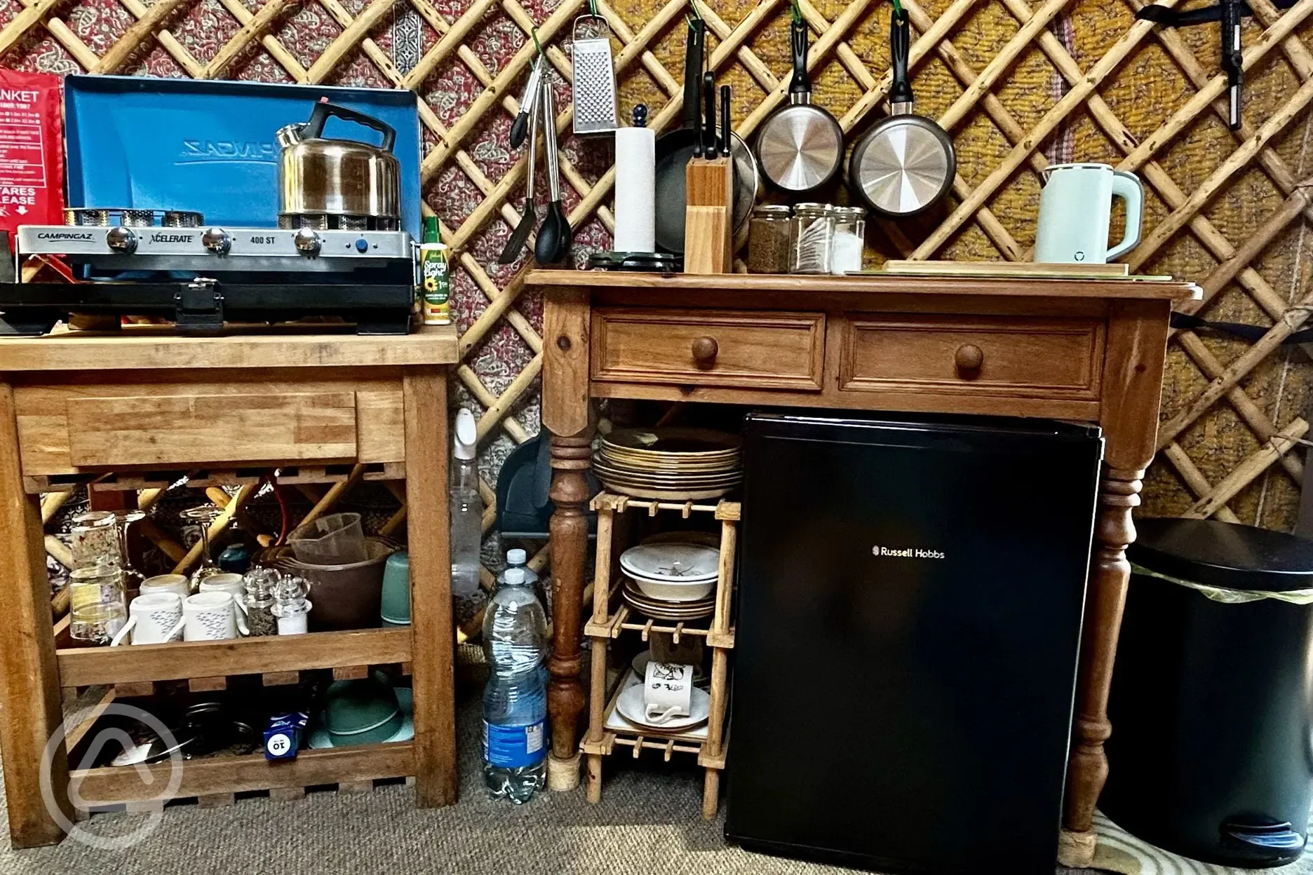 Primrose Yurt fully-equipped campers kitchen with fridge, hob, and utensils