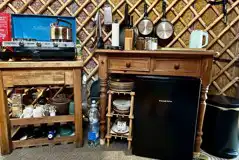 Primrose Yurt fully-equipped campers kitchen with fridge, hob, and utensils