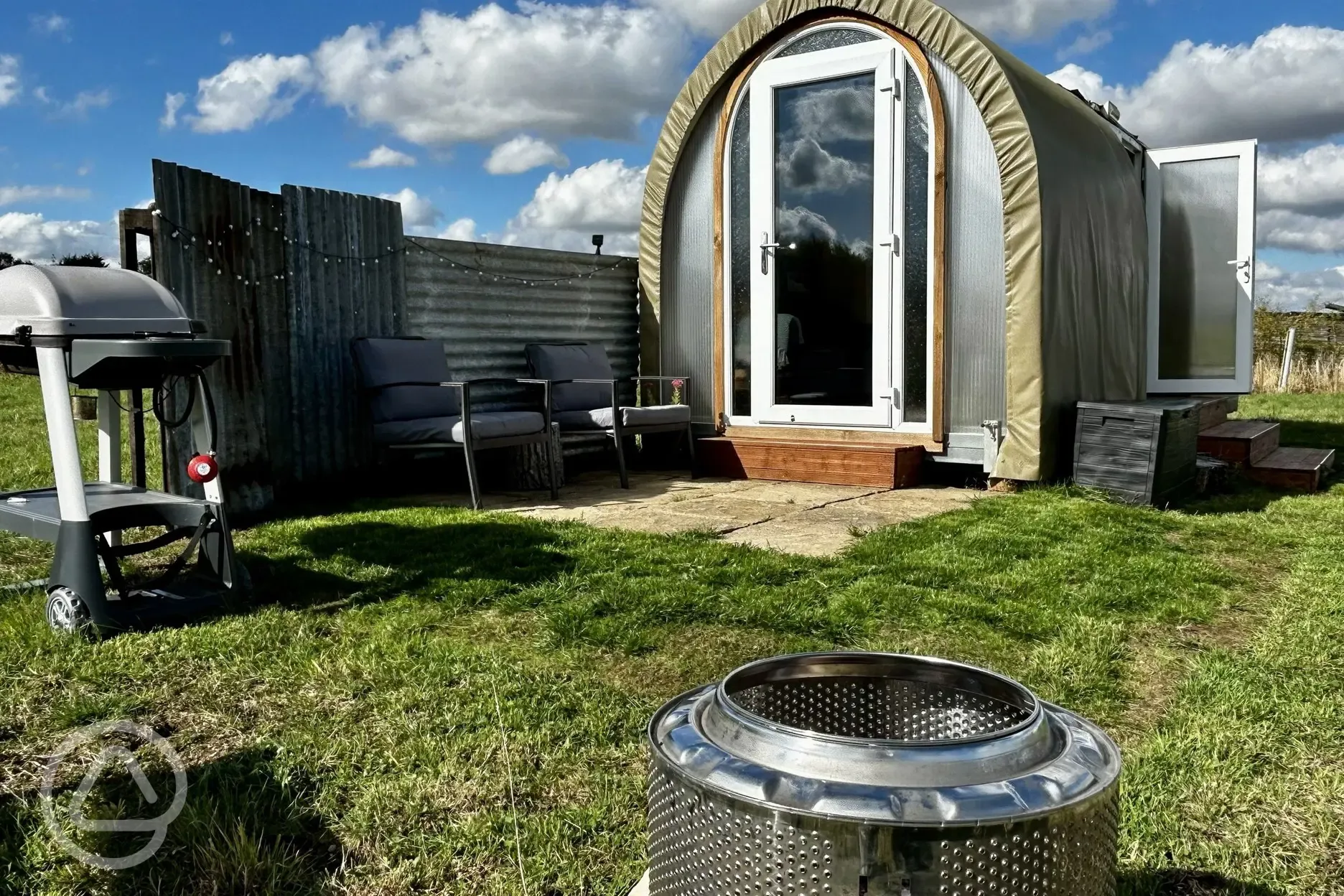 Coco Pod private patio with outdoor seating, fire pit, and BBQ