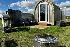 Coco Pod private patio with outdoor seating, fire pit, and BBQ