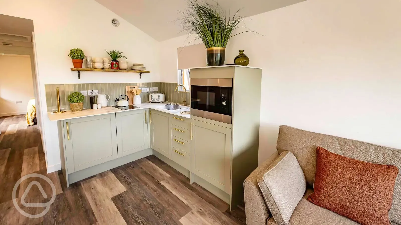 Cabin kitchen with a fridge/freezer, microwave, kettle, hob, sink and toaster