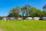 Grass touring pitches with children's play park in the centre