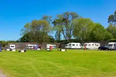 Grass touring pitches with children's play park in the centre