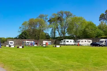 Grass touring pitches with children's play park in the centre