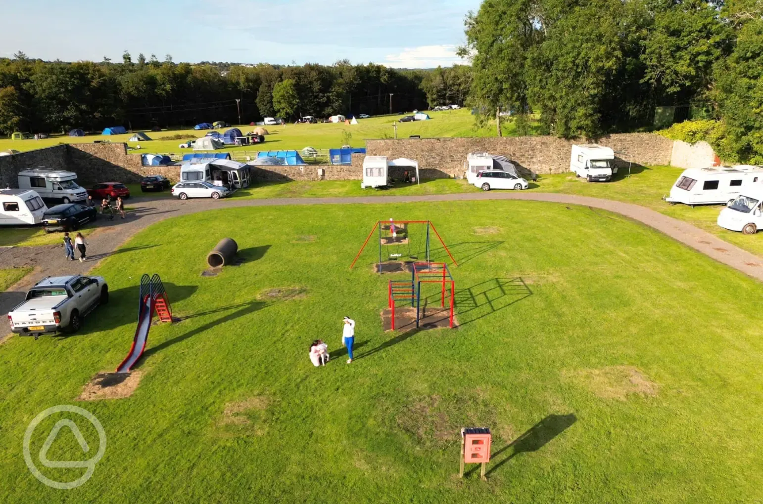 Aerial of the touring pitches and play park at Treborth Hall Farm Caravan Site