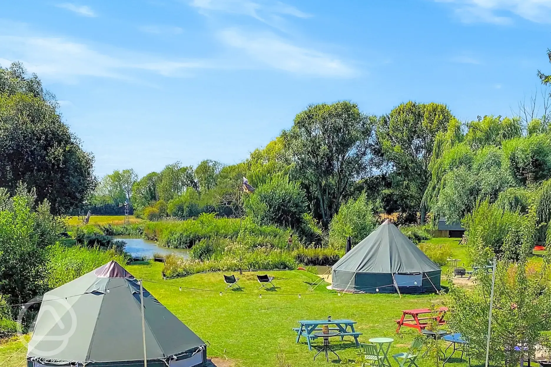 Bell tents at Rum Bridge with lakeside views and picnic tables