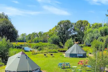 Bell tents at Rum Bridge with lakeside views and picnic tables