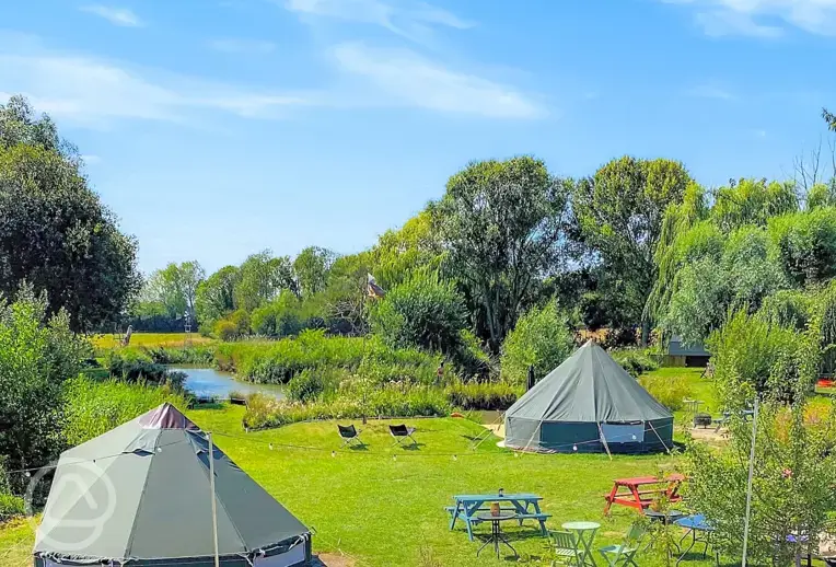Bell tents at Rum Bridge with lakeside views and picnic tables