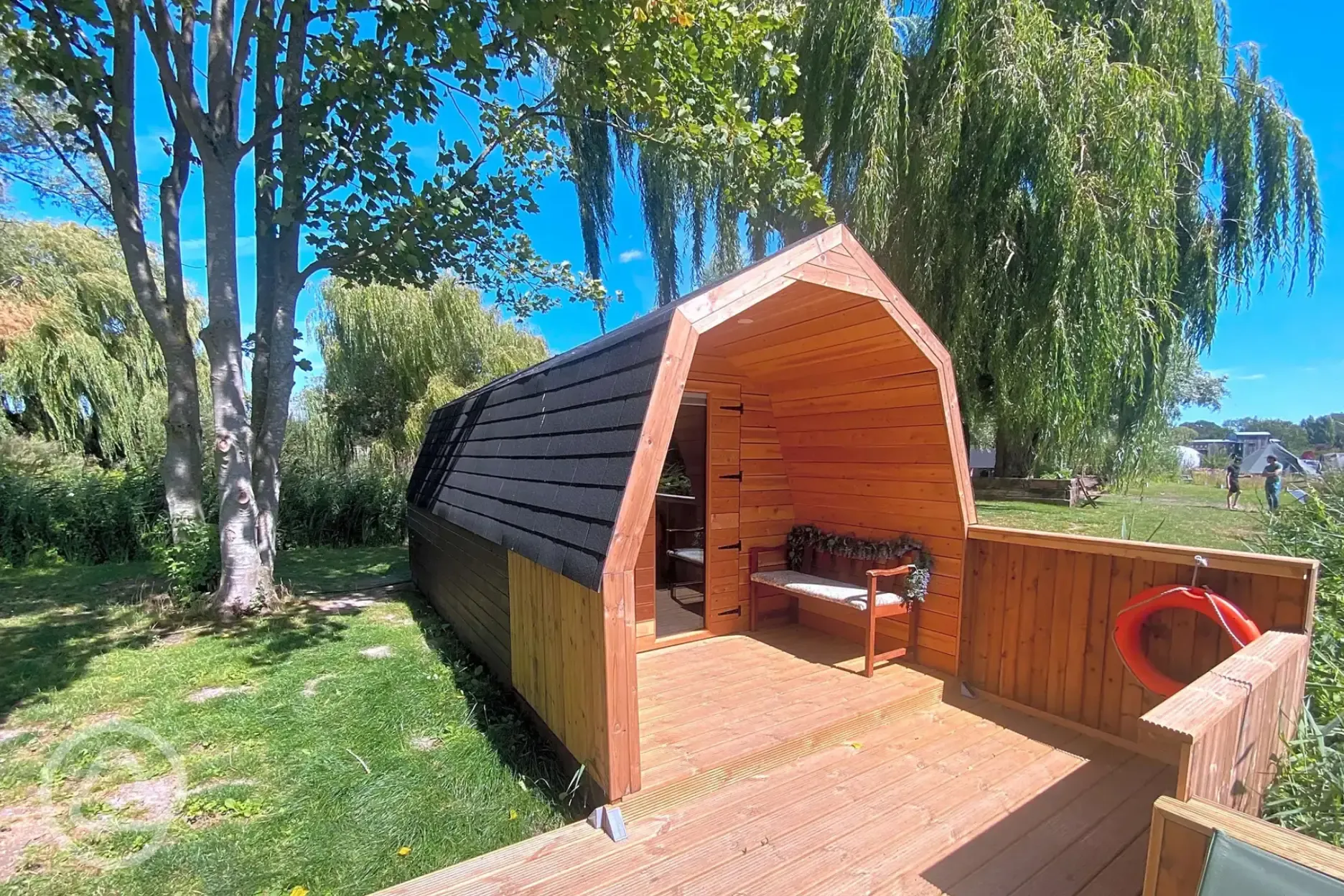 Lakeside camping pods with picnic bench