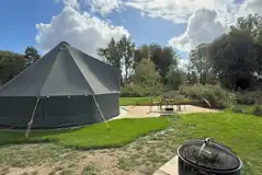 Quirky Carp bell tent fire pit and decking area Quirky Carp bell tent fire pit and decking area