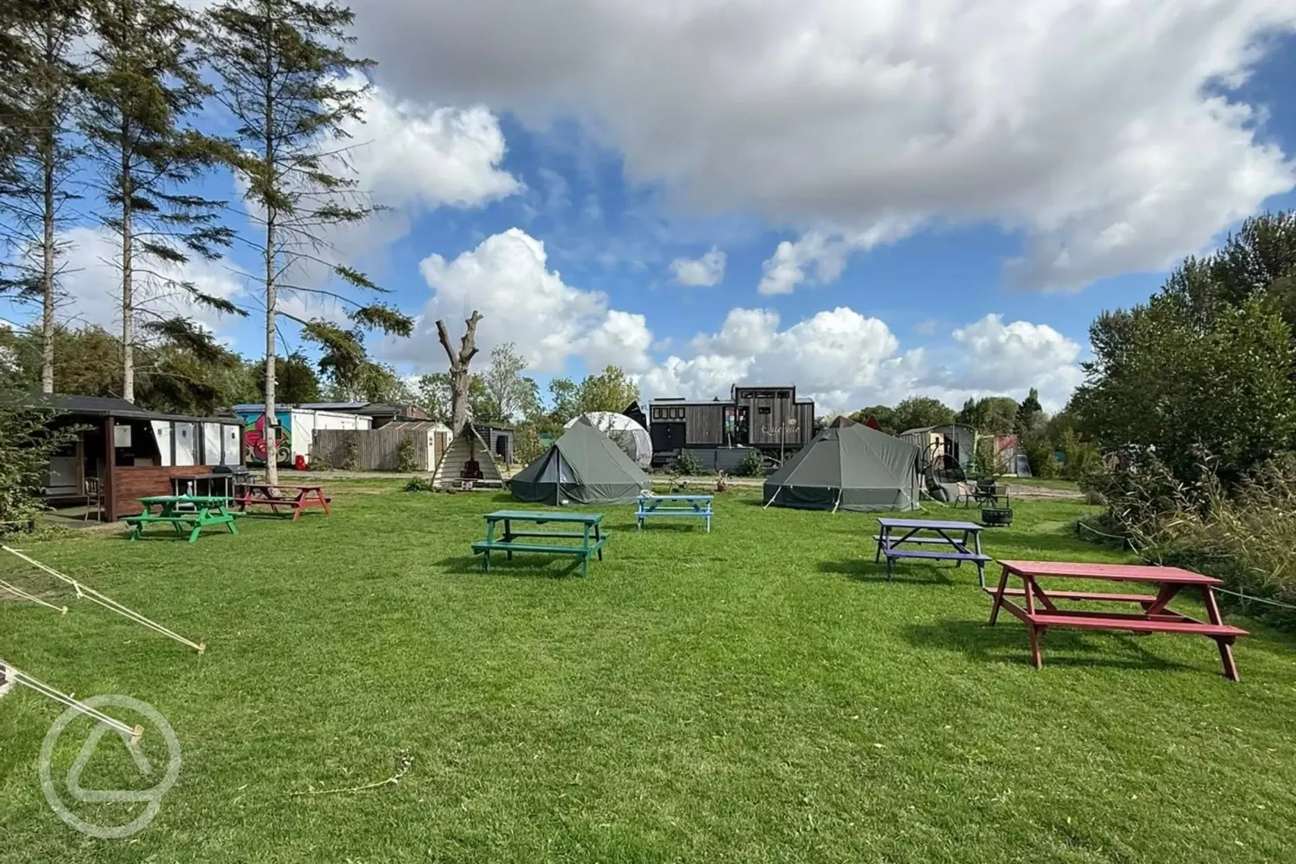 Overview of bell tents and picnic benches