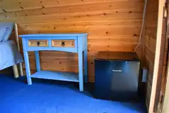 Hart's camping pod storage area and mini fridge