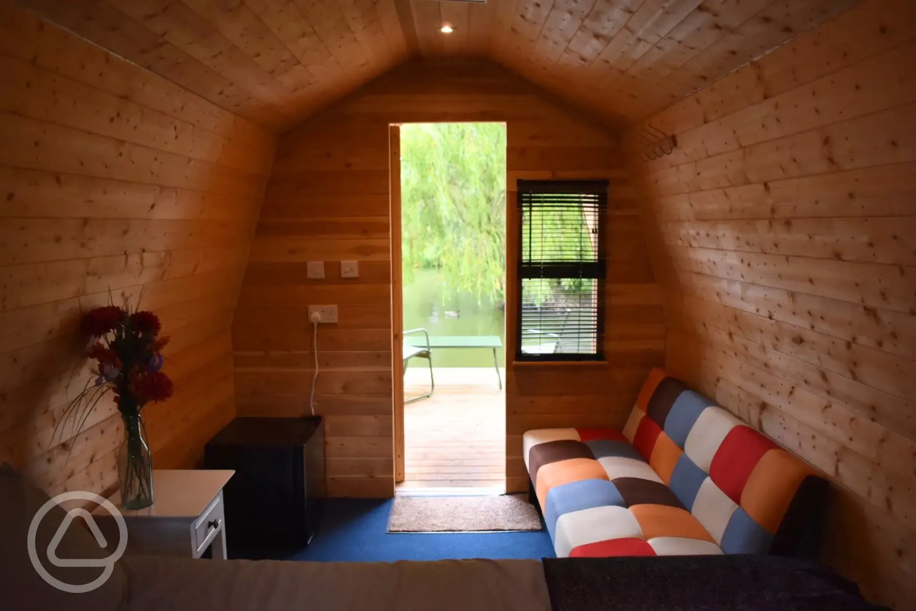 Valerie's pod interior with outdoor seating and lake views