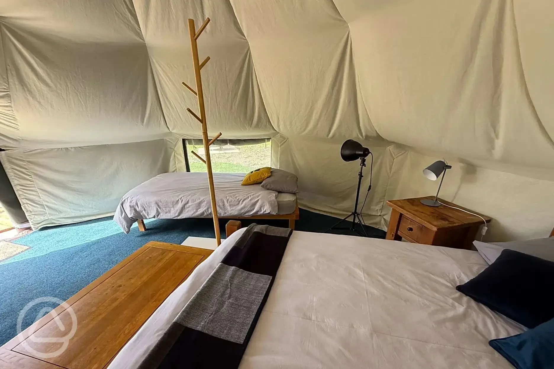 Quirky Carp bell tent interior with king sized bed and singles