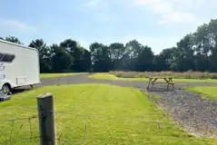 Fully serviced hardstanding and grass touring pitches with picnic benches