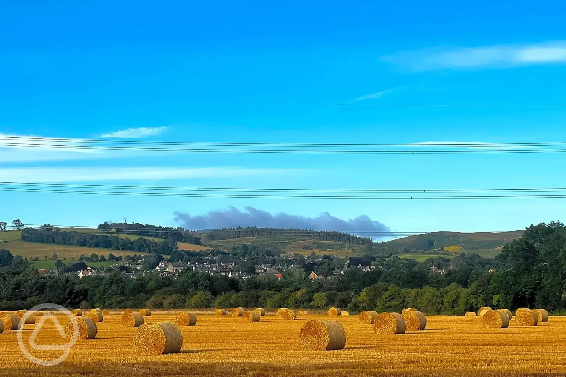 Harvest time at the site with far reaching views of Northumberland National Park