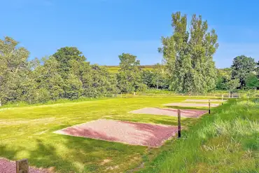 Non electric gravel hardstanding pitches with views of the Cheviot Hills