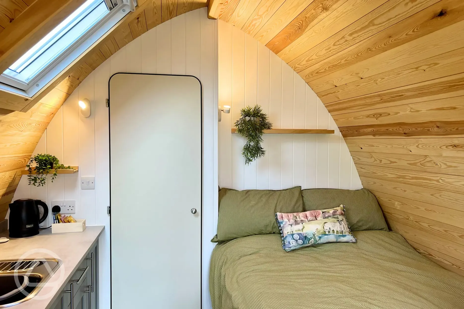 Glamping pod interior with a double bed with bedding provided