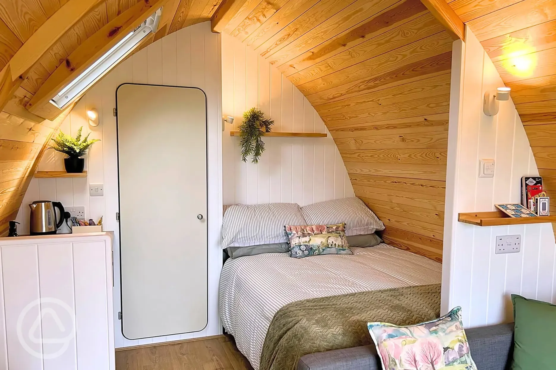 Glamping pod interior with a double bed with bedding provided