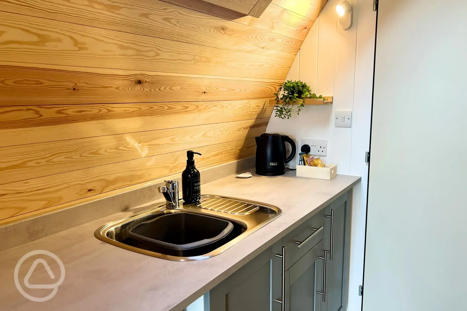 Equipped kitchenette with a sink, fridge, microwave, air fryer and toaster