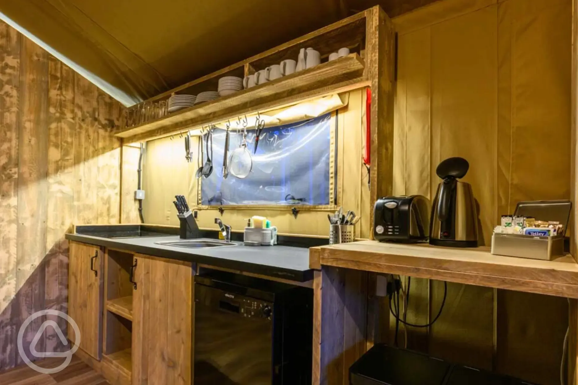 Large Deluxe Safari Tent kitchen with a fridge, kettle, toaster and sink