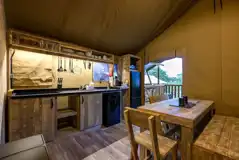 Premium Safari Tent dining area and equipped kitchen