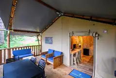 Verandah of a Deluxe Safari Tent with outdoor seating and dining area