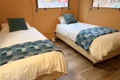 Twin profiling orthopaedic beds in the Accessible Deluxe Safari Tent