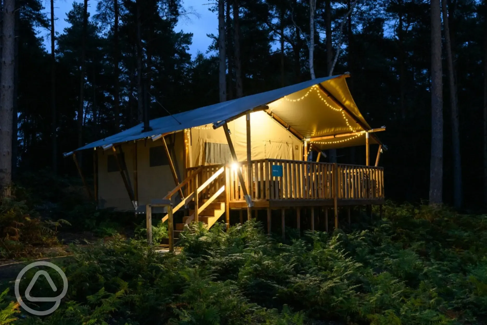 Safari tents at night with fairy lights