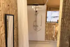 Shower in the accessible wet room of the Accessible Deluxe Safari Tent
