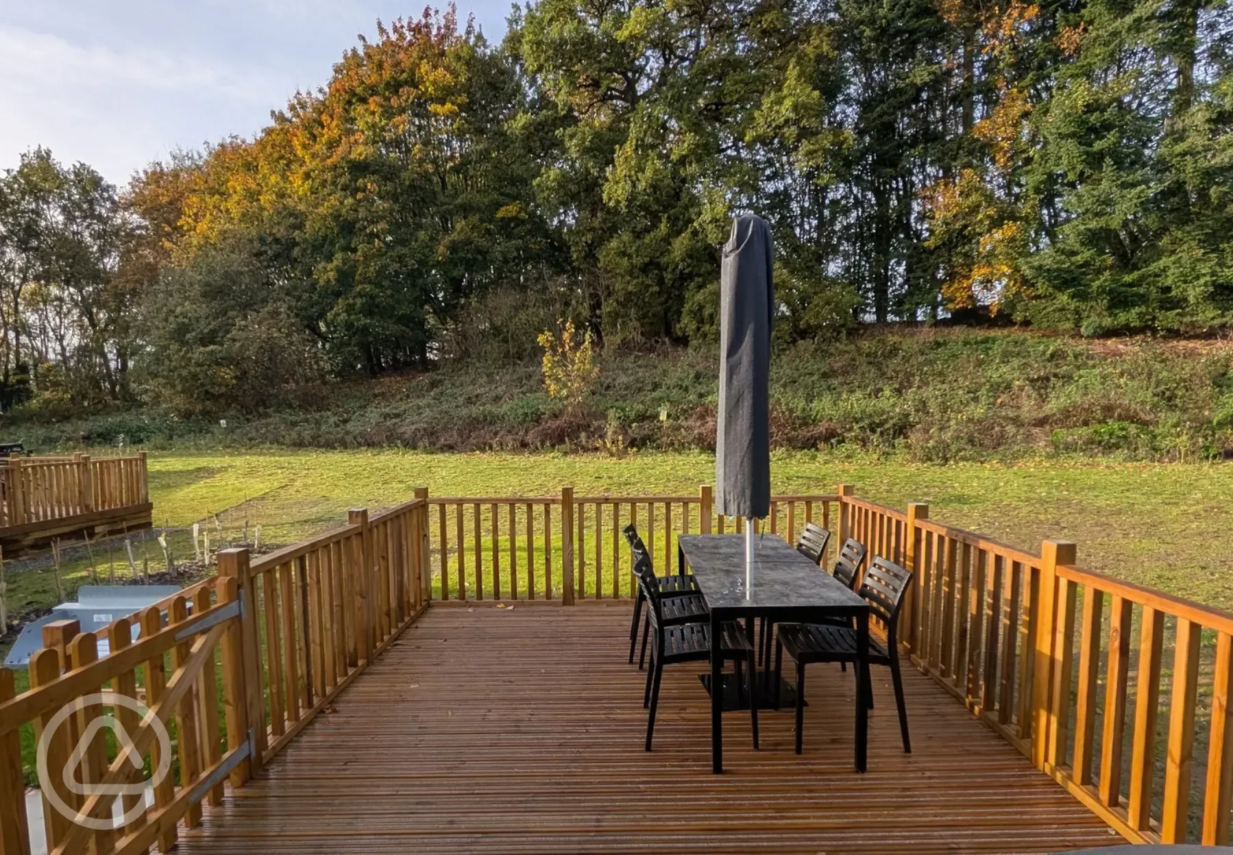 Superior glamping cabins with an outdoor deck, furniture and parasol