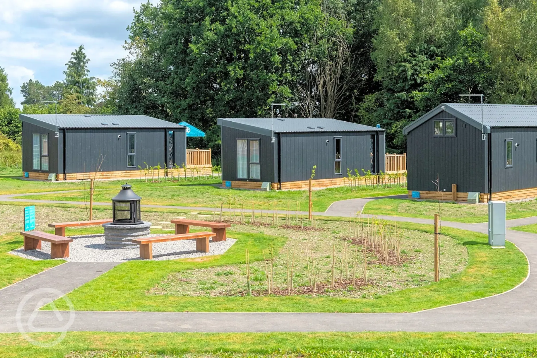 Glamping pods and cabins with the communal fire pit area
