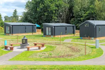 Glamping pods and cabins with the communal fire pit area