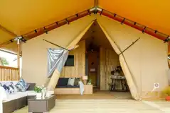 Premium Deluxe safari tent with an outdoor coffee table, sofa and deck