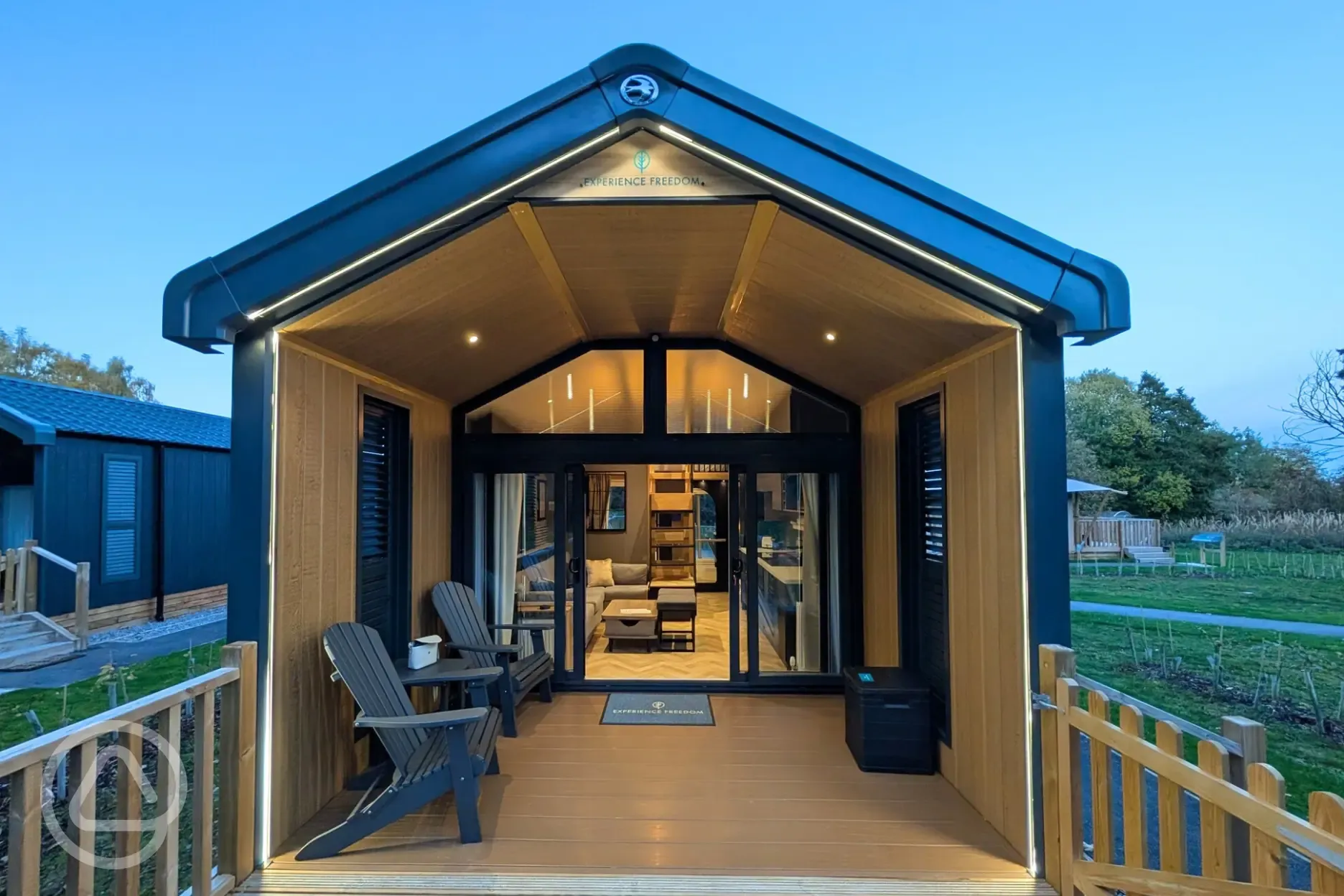 Superior glamping cabins with an outdoor deck and night lighting