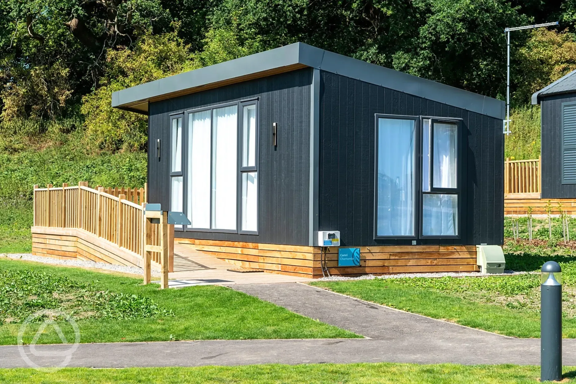 Deluxe ensuite glamping pods with and outdoor deck, table, chairs and brick BBQ