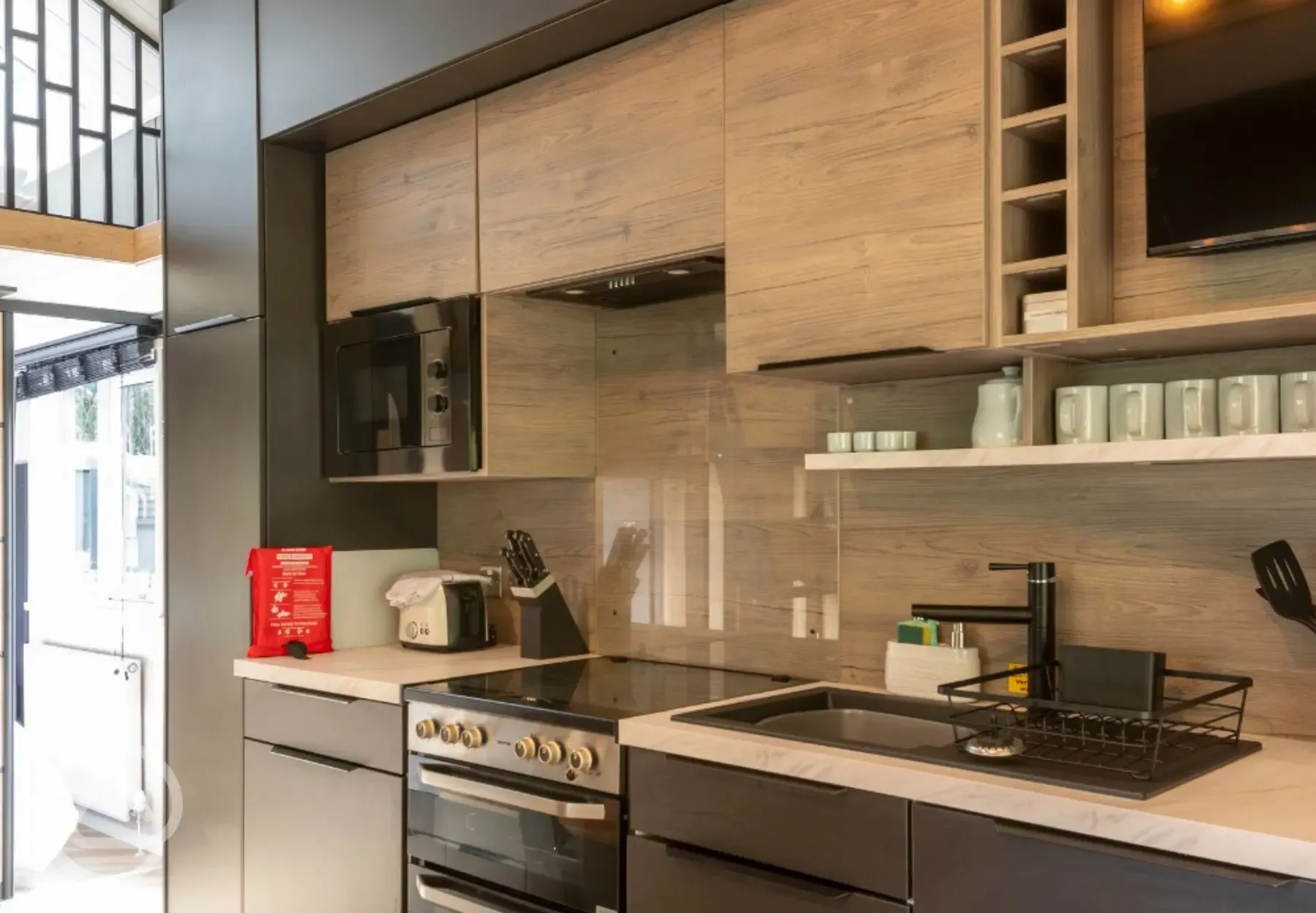 Kitchen with an oven, hob, toaster, fridge, kettle and microwave