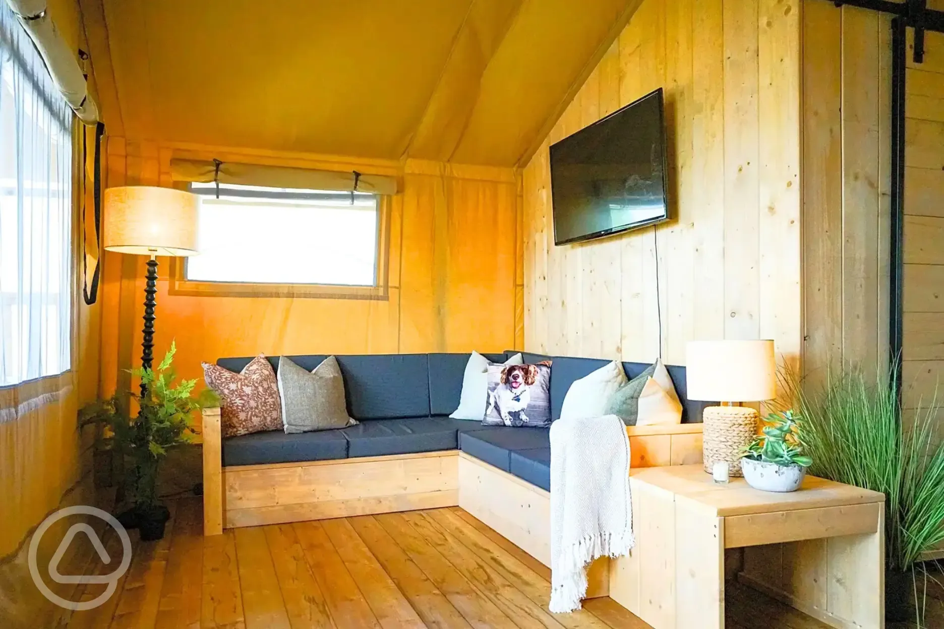 Deluxe safari tent with a sofa and TV