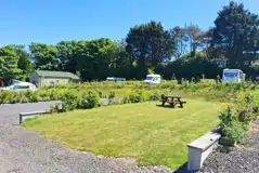 Hardstanding and grass (13m x 7.2m) pitches with optional electric hook ups