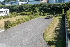 Terraced fully serviced hardstanding pitches with a picnic bench