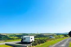 Terraced hardstanding and grass pitches with countryside views