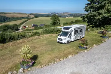Grass pitches with optional electric overlooking Dartmouth countryside