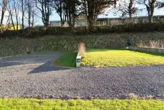 Hardstanding and grass pitches with small dividing walls between