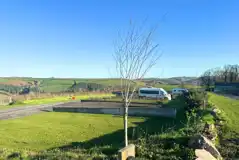 Terraced hardstanding and grass pitches with countryside views