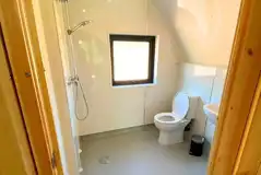 Ensuite wetroom with a toilet, shower, hand basin and two shower heads