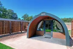 Glamping pod with a patio area and glass front
