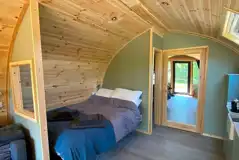 Glamping pod interior with a double bed (bedding and towels provided)
