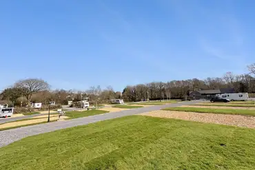 Llanina Caravan Park with large grass areas between pitches