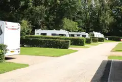 Fully serviced hardstanding pitches with hedges between