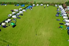 Electric grass pitches set around the edge of the camping field Electric grass pitches set around the edge of the camping field
